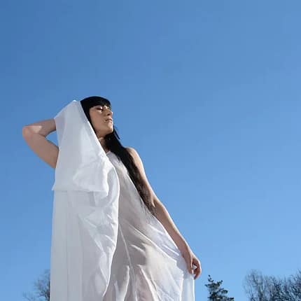 Album art for God's Imagination by Jess Lamb, showing Jess in a flowing white dress with the blue sky in the background.